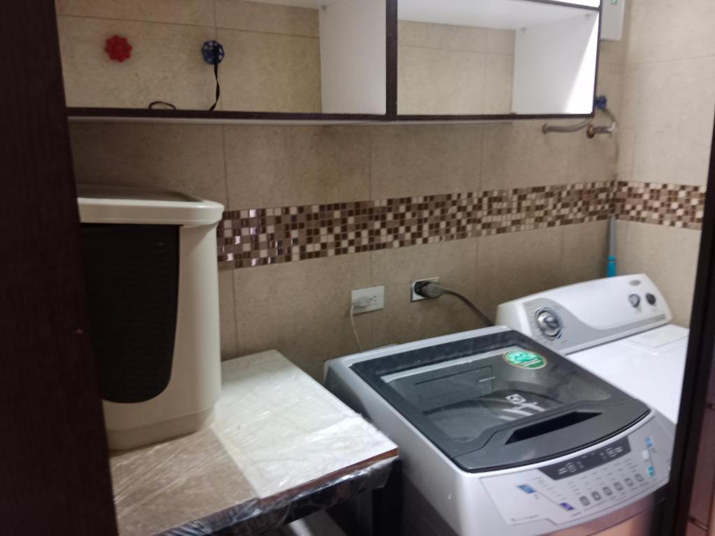 a small kitchen with a stove and a sink at Departamento completo 2 in Quito