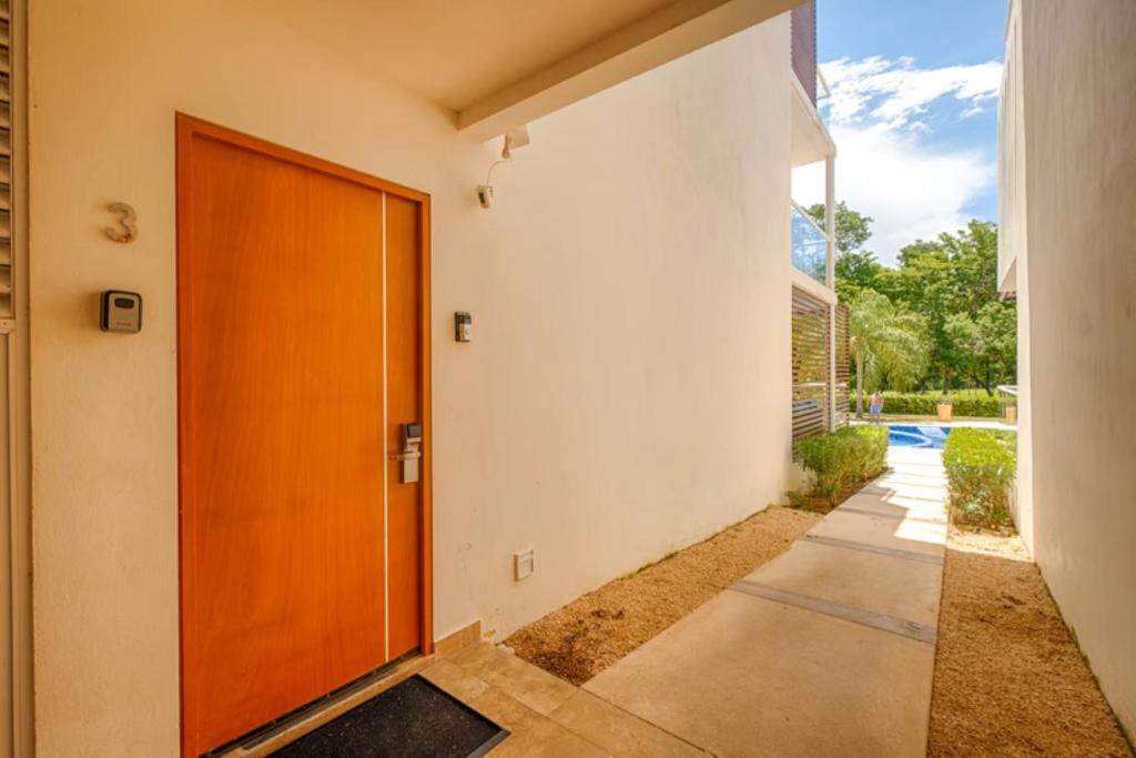 a door to a house with a driveway at Luxurious Tulum Terrazas 2-bedroom Condominiuml in Akumal