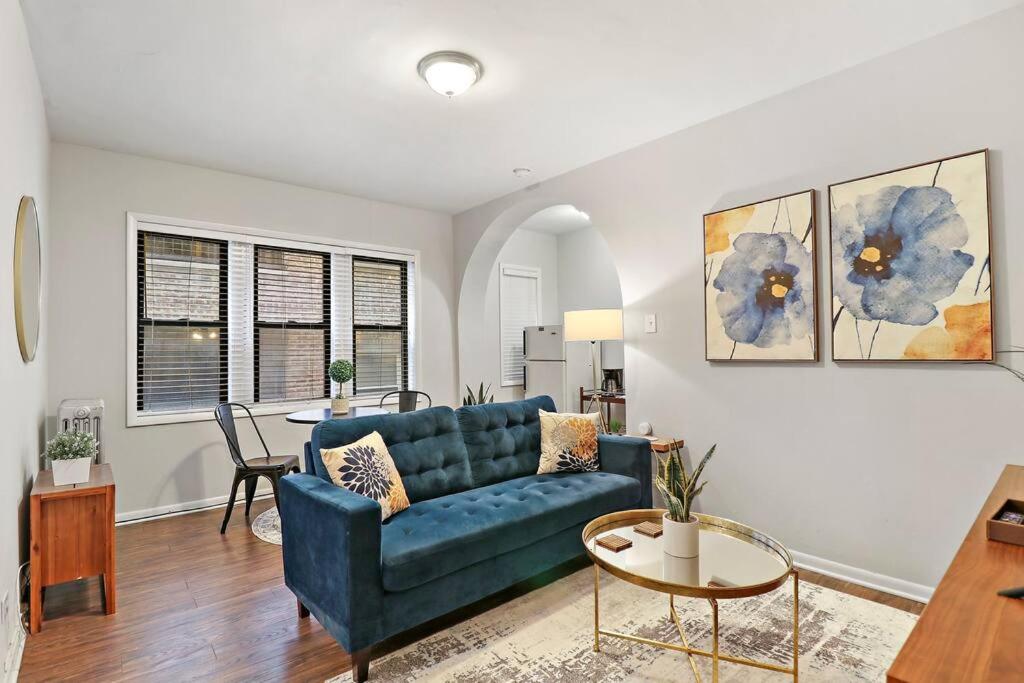 a living room with a blue couch and a table at Modern Chic 1BR in Downtown Chicago - Dorchester 204 in Chicago