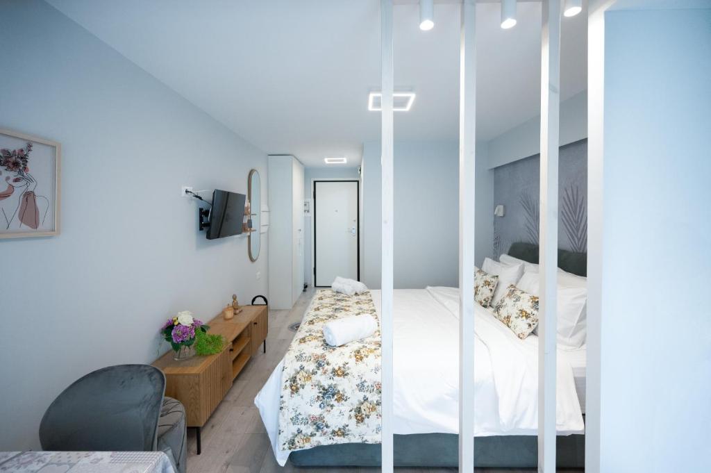 a bedroom with a bed with a glass wall at La Luna Lux Studio in Ioannina