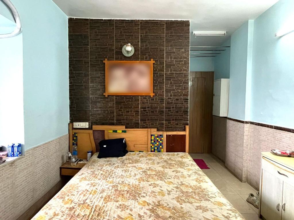 a room with a bed and a brick wall at Calm Private Room with Beautiful View in Mumbai