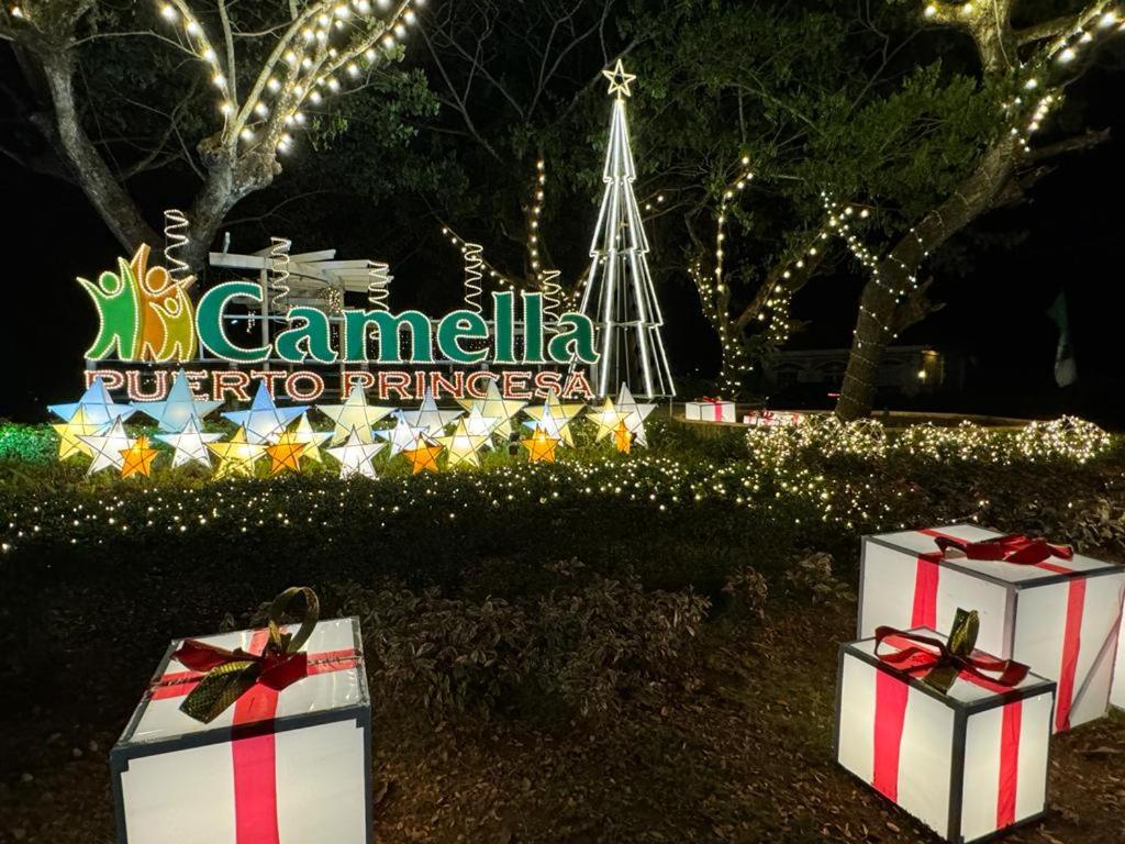 two presents in front of a sign with a christmas tree at Summer10th Verdant Palawan in Puerto Princesa City