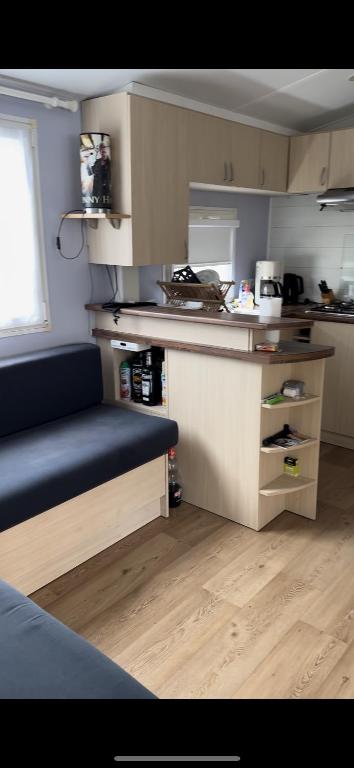a small kitchen with a blue bench in a room at Camping Lou PK2 emplacement 15 in Sainte-Eulalie-en-Born