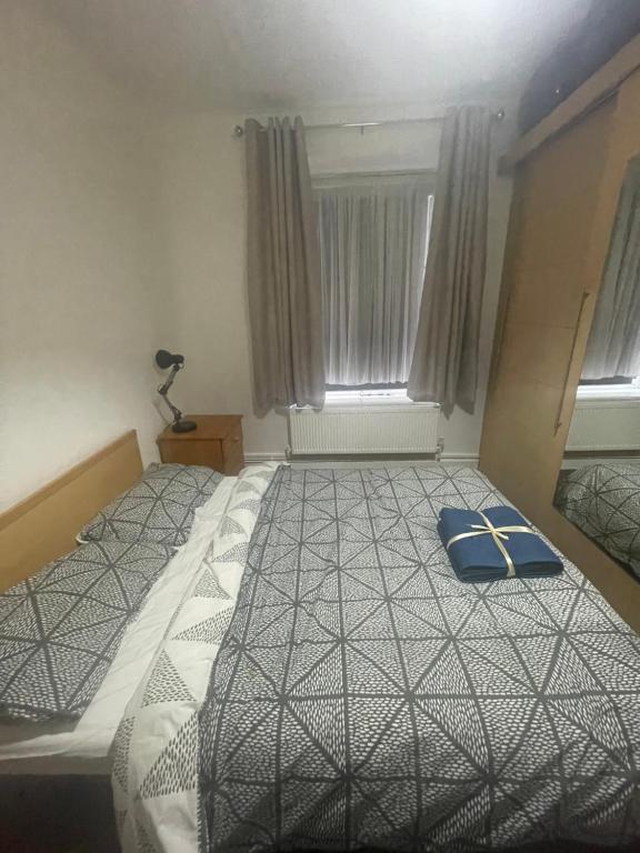a bedroom with a bed with a cross on it at Super Streatham Room in London