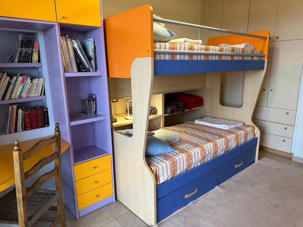 a bedroom with a bunk bed with a ladder at ΔΩΜΑΤΙΟ ΜΕ ησυχία και θέα in Patra