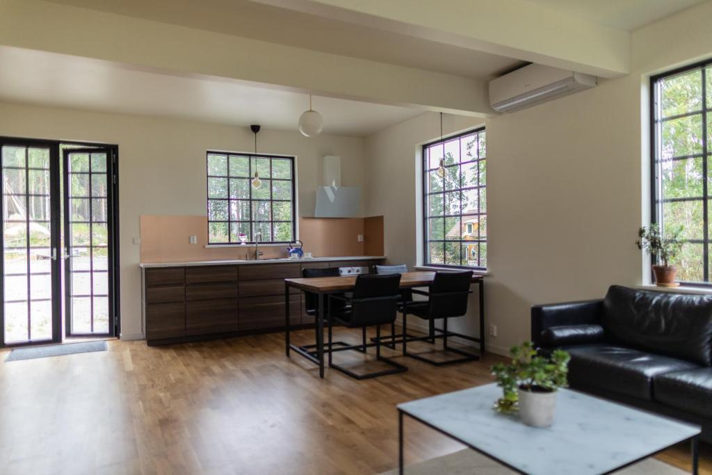 a living room with a couch and a table at A Place to Call Home in Skellefteå