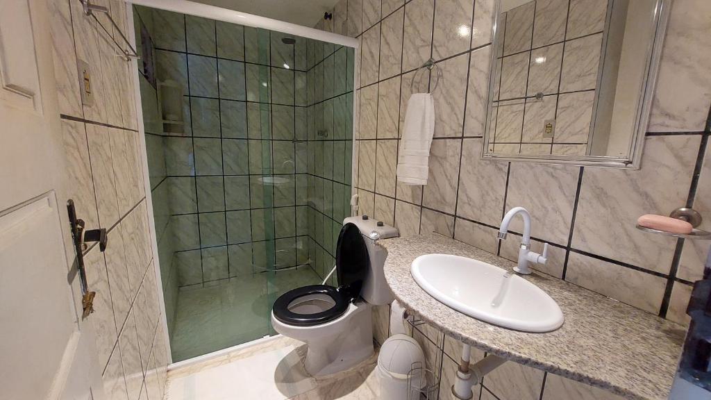 a bathroom with a toilet and a sink and a shower at Will's House in São Luís