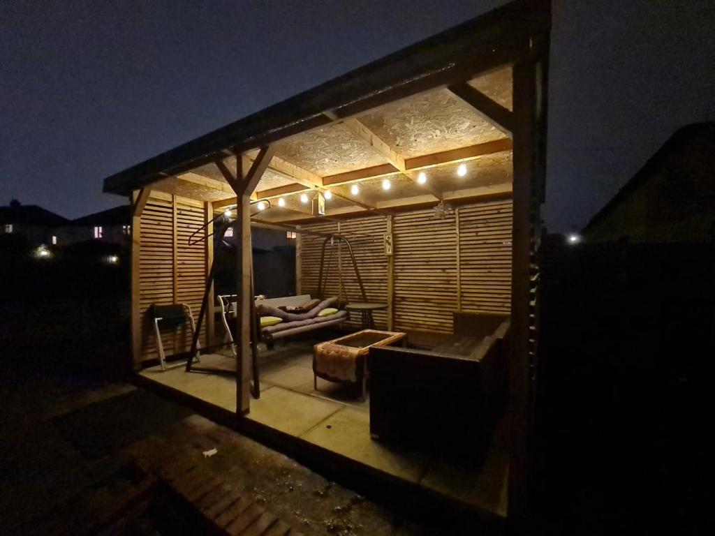 a house with a living room with lights on it at The Standalone - 4 Bedroom Home with Garden by Wild in London