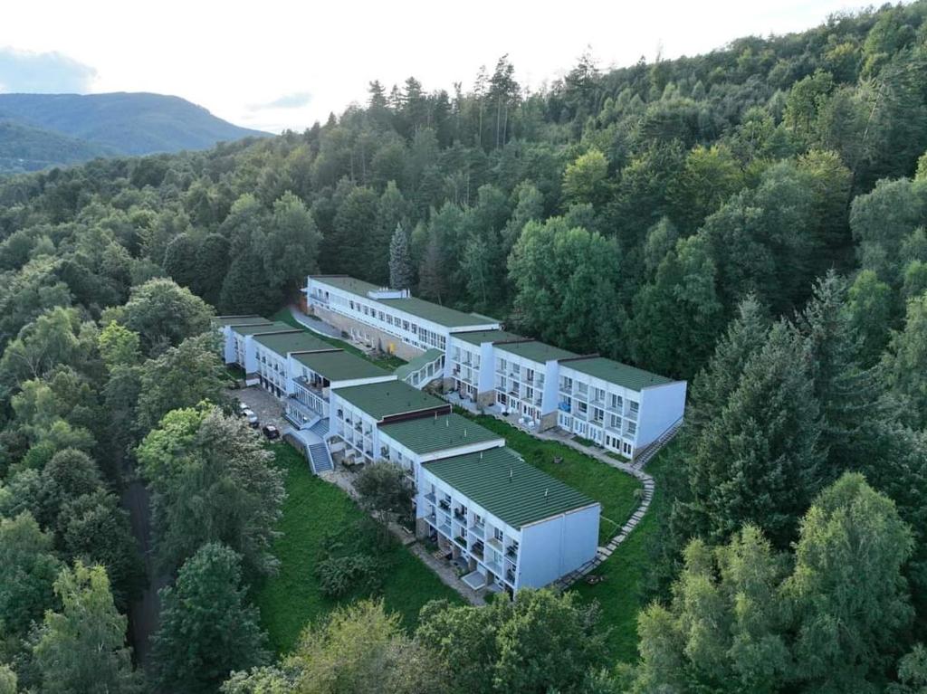 an aerial view of a building in the middle of a forest at Barbara 76 in Ustroń