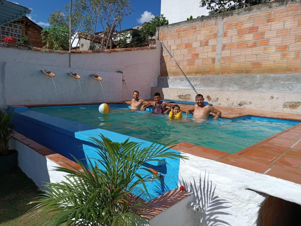a group of people in a swimming pool at ADVENTURE Hostel in San Gil