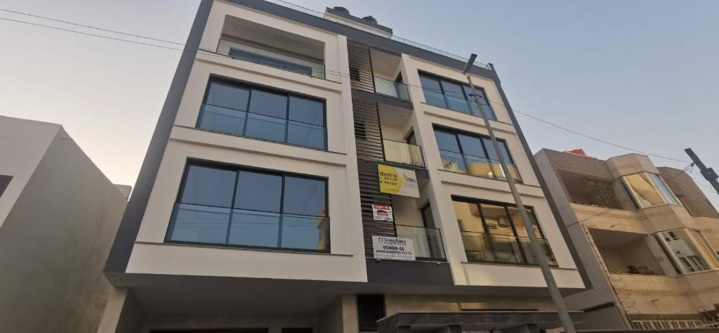 a building with many windows on the side of it at Ondas Relax House in Praia