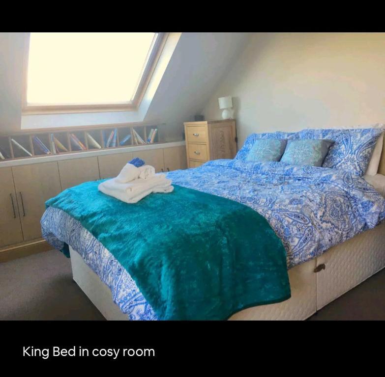a bedroom with a king bed in a cozy room at Scrabo View - King Bedroom with private bathroom in Comber