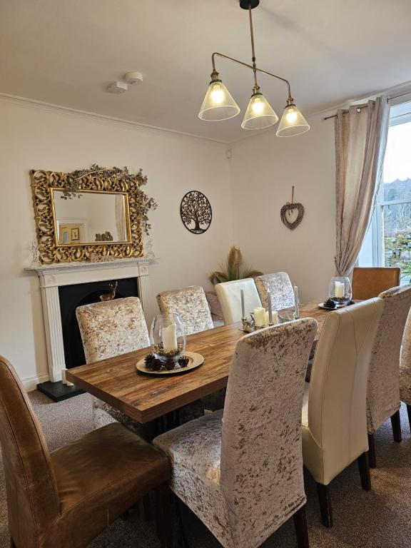 a dining room with a wooden table and chairs at Antfield house in Inverness