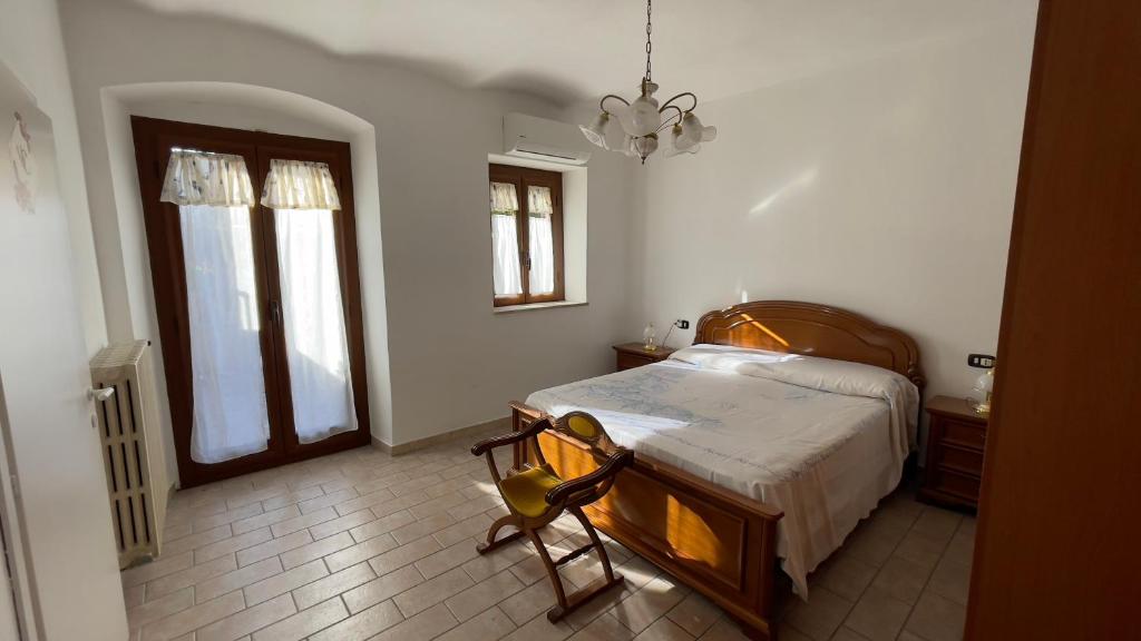 a bedroom with a bed and a chandelier at Flowers & Angels Home in Santa Maria degli Angeli