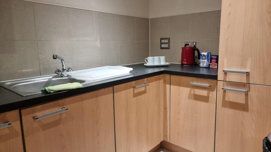 a kitchen with a sink and a counter top at Two bed Apartment free parking near Colindale Station in Colindale