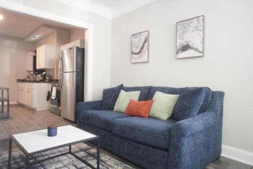 a living room with a blue couch and a table at Cozy Apt Near Midway Airport & Downtown in Chicago