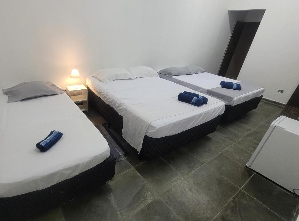 Postel nebo postele na pokoji v ubytování Pousada Genesis Guaruja