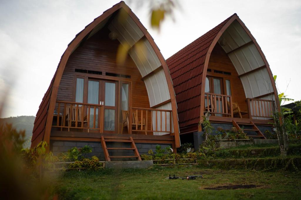 a house with two large domes on top of it at Family rinjani bungalow in Sajang