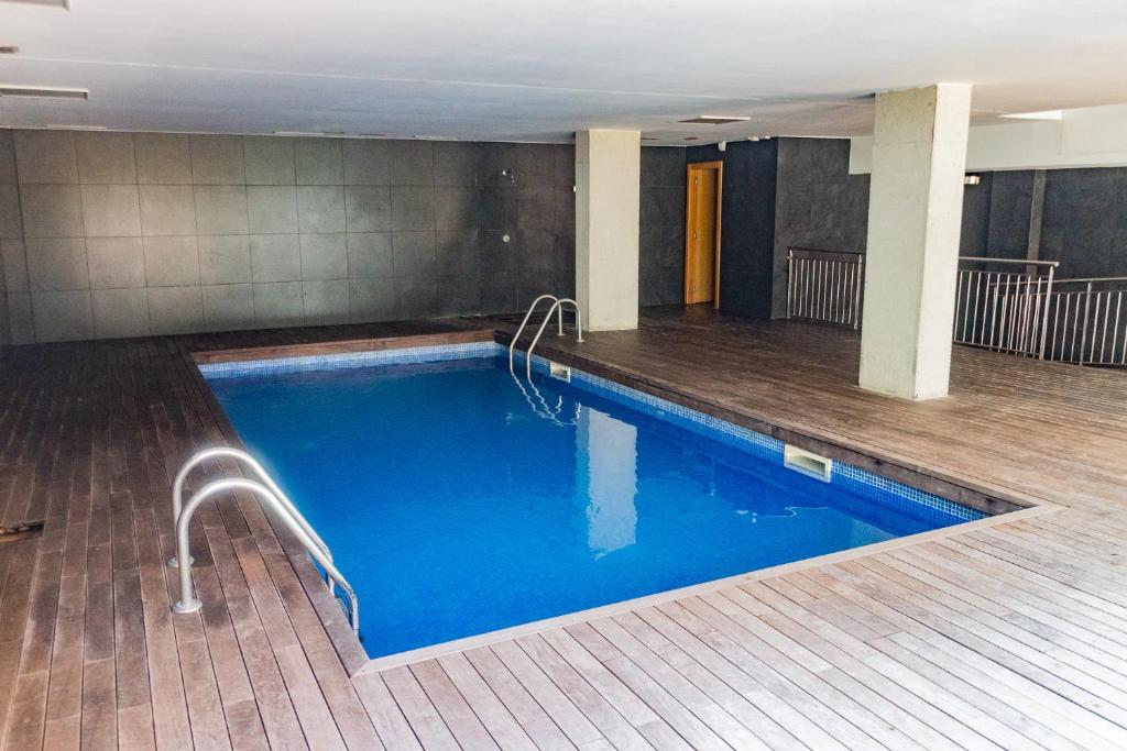 a large swimming pool in a building at Luxe Forum Beach Terrace in Sant Adria de Besos