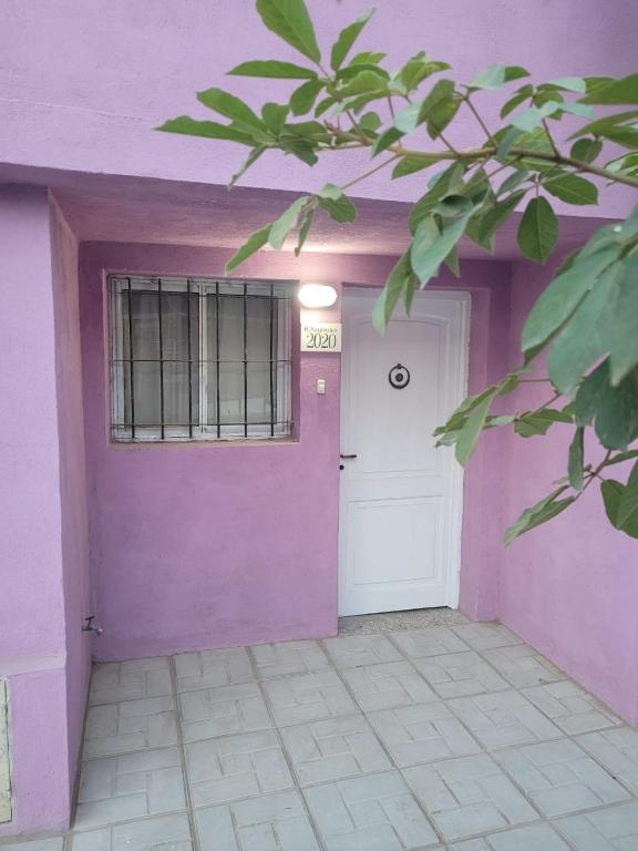 a purple house with a door and a window at "La Violeta" casa con jardín, San Pedro in San Pedro