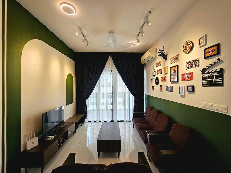 a living room with a couch and a table and a television at Bay Laurel @ Country Garden, Danga Bay, Johor Bahru, Johor in Johor Bahru