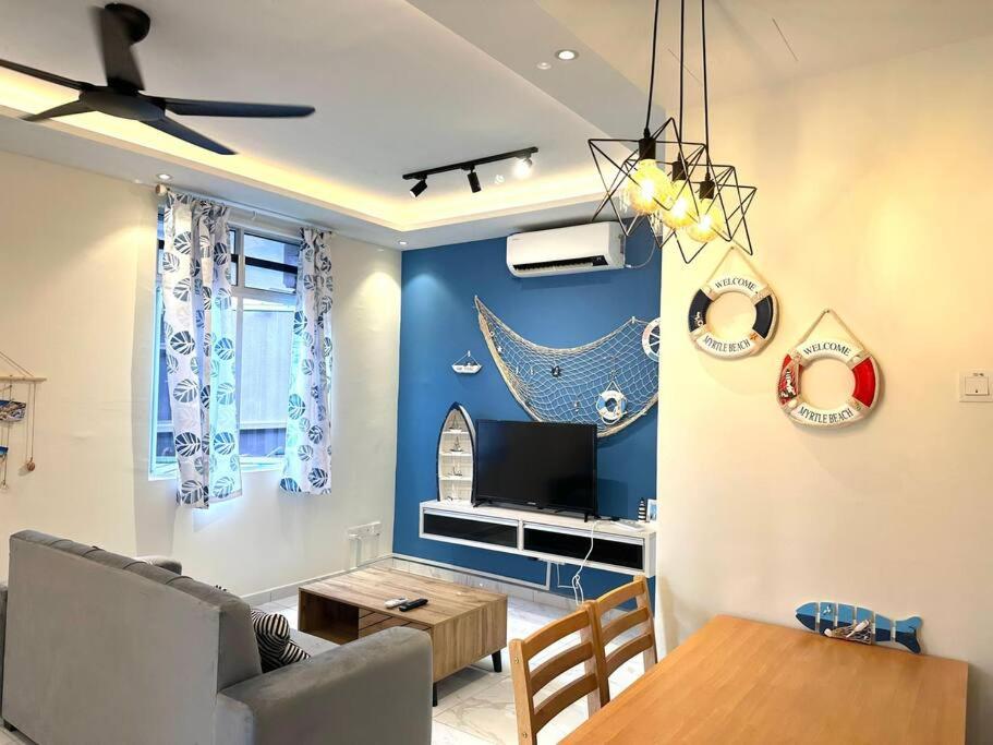 een woonkamer met een bank en een tafel bij Blue Ocean House 3br DatoOnn JB in Johor Bahru
