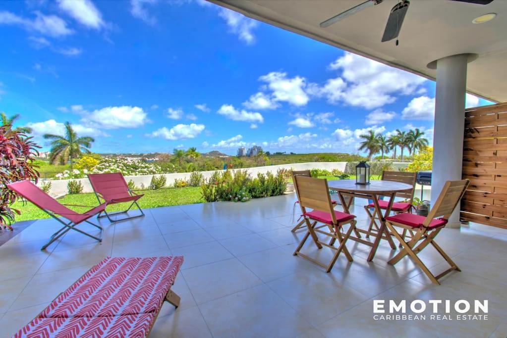 a patio with a table and chairs and a view at Appartement 2 chambres Blue Marine Maho Sxm in Maho Reef