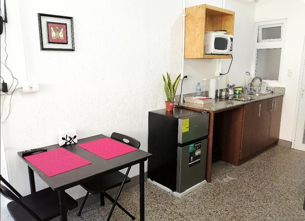 a small kitchen with a table and a counter at Apto moderno zona 1 in Guatemala