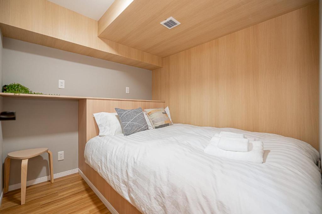 Postel nebo postele na pokoji v ubytování Sakura Suite 404