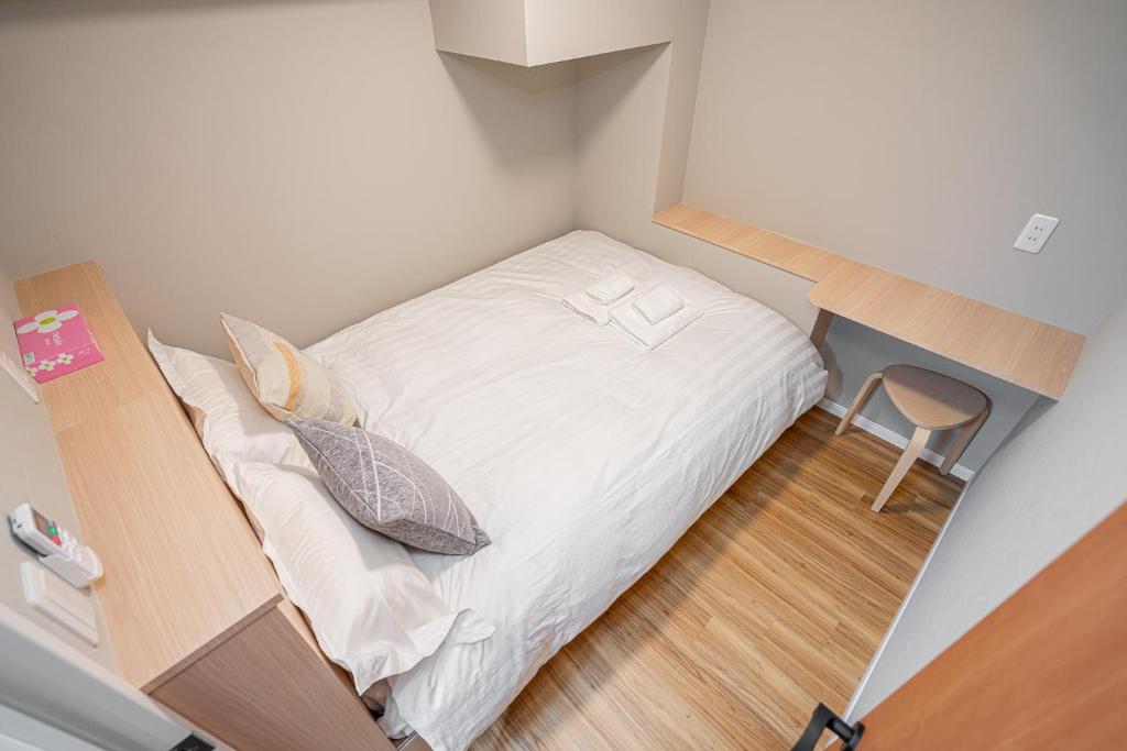 Postel nebo postele na pokoji v ubytování Sakura Suite 404