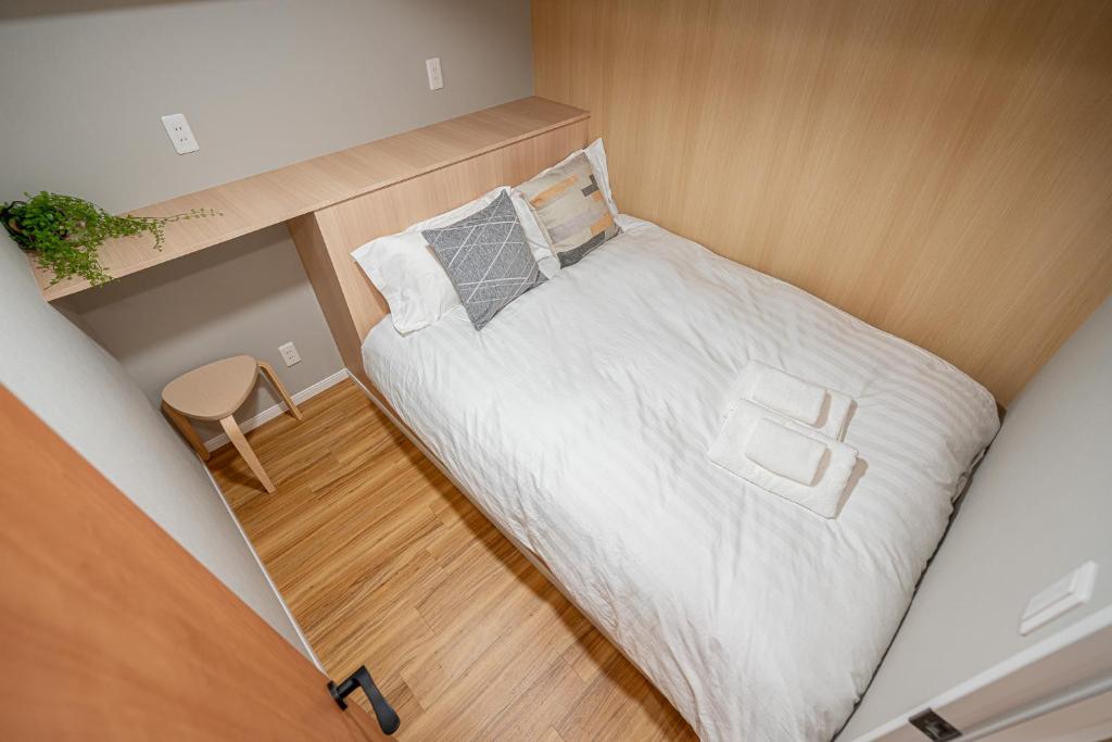 Postel nebo postele na pokoji v ubytování Sakura Suite 404