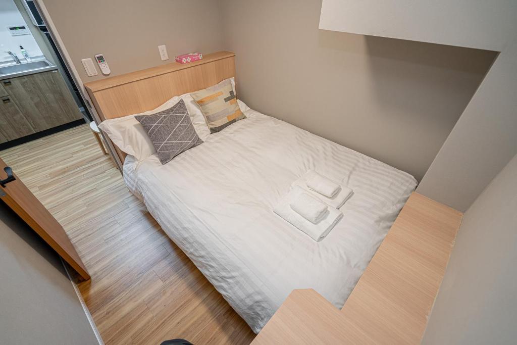 Postel nebo postele na pokoji v ubytování Sakura Suite 404