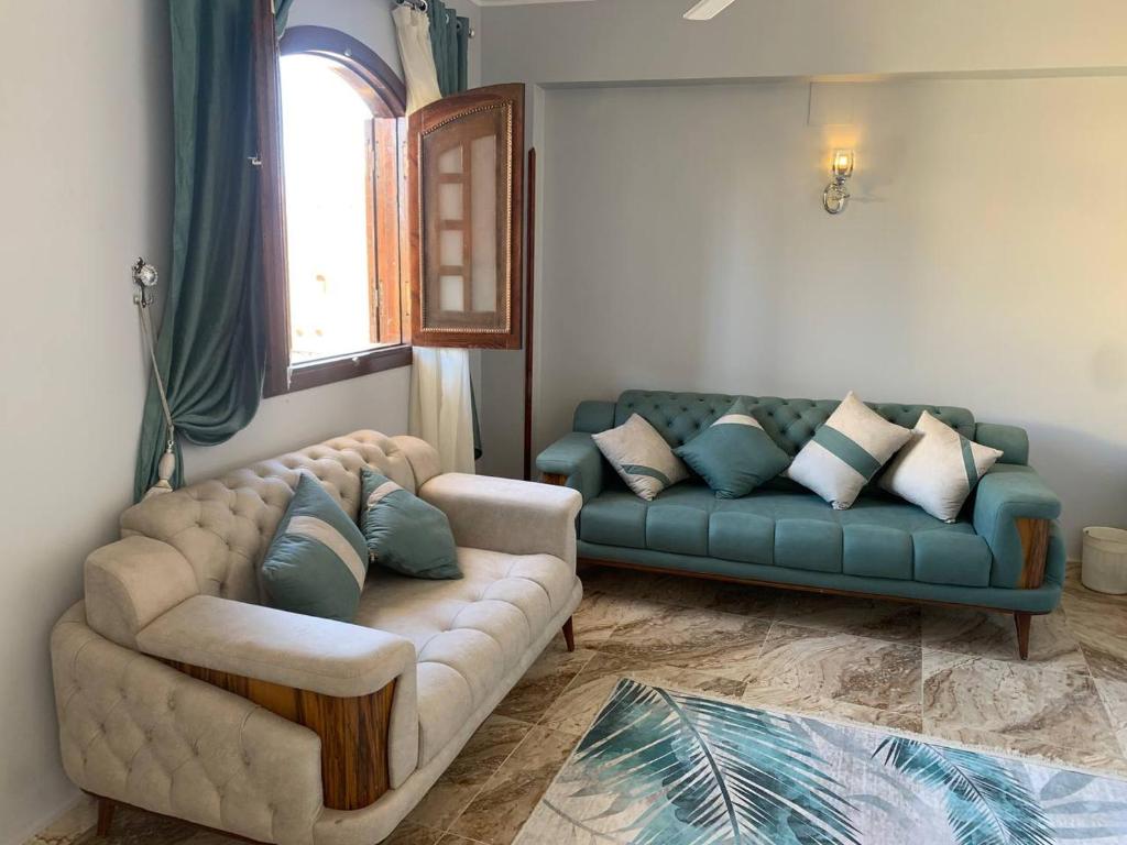 a living room with a couch and a window at joy house in Luxor