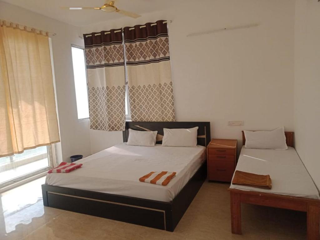 Ліжко або ліжка в номері Suman beach House