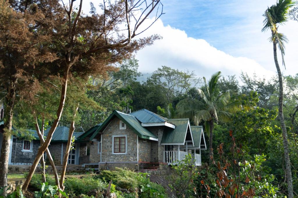 a house with a green roof in the forest at Beragala Serene Villa in Beragala