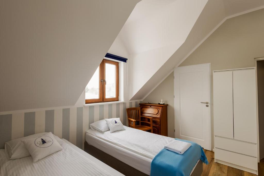 Postel nebo postele na pokoji v ubytování Czar Mamry Apartamenty