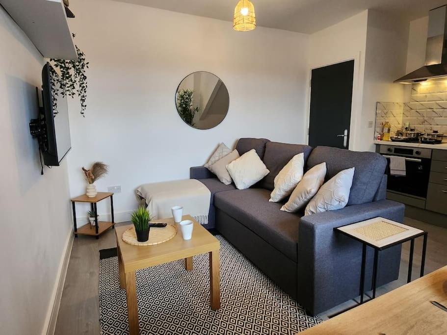 a living room with a blue couch and a table at SuperValue Suite 3 - Fast WiFi, Hotel Linen, Keyless Entry, City only 10 Mins - BY PROPERTY PROMISE in Cardiff
