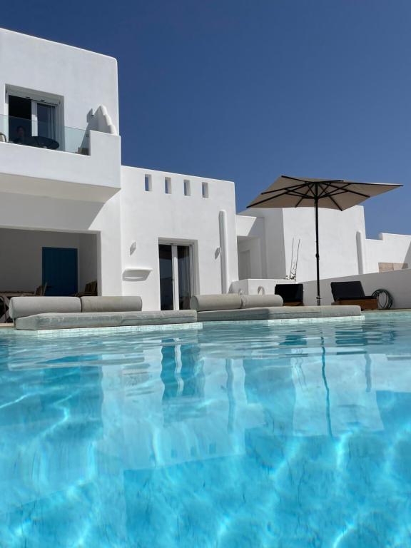 a swimming pool in front of a villa at Depis Edem private villas naxos in Plaka