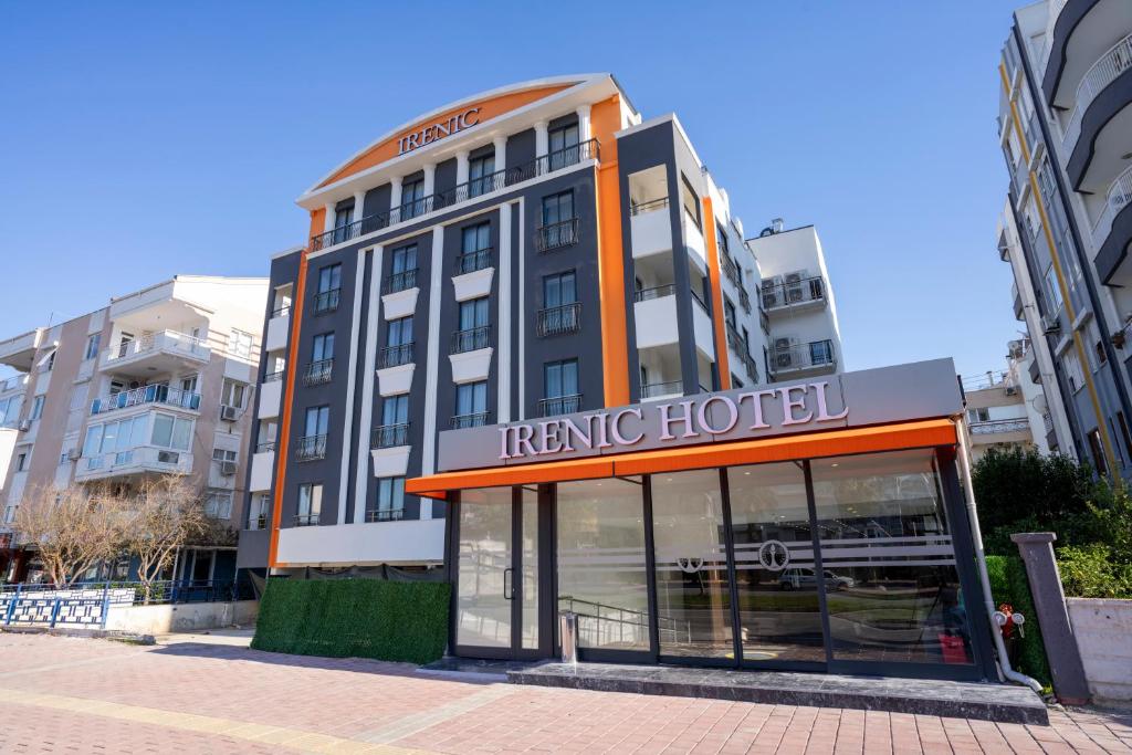 a hotel building with a sign in front of it at IRENIC HOTEL in Antalya