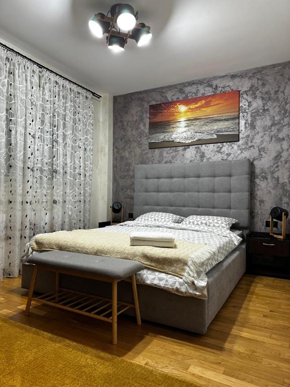 a bedroom with a bed and a ceiling at Paulina Apartament in Timişoara
