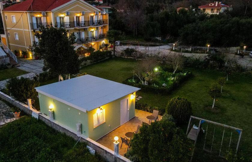 an aerial view of a house at night with lights at Dallas Hotel in Svoronata