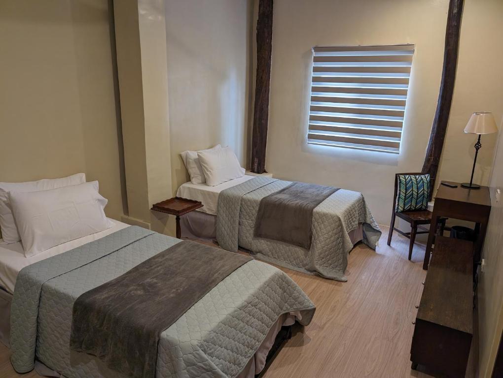 מיטה או מיטות בחדר ב-Villanueva House