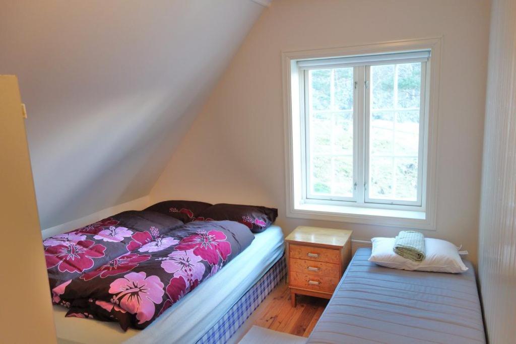 a small bedroom with a bed and a window at Flørli 4444 Lysefjorden - Director's residence in Sandnes