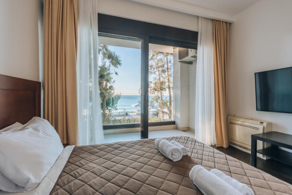 a bedroom with a bed with a view of the ocean at Apartments Kuce Lekovica Beach & snack bar- Bistro in Bar