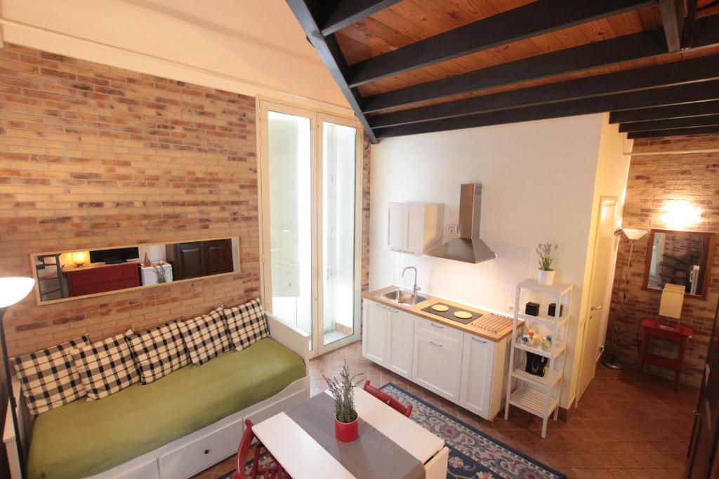 a room with a kitchen and a sink in a room at Amenano Apartments in Catania