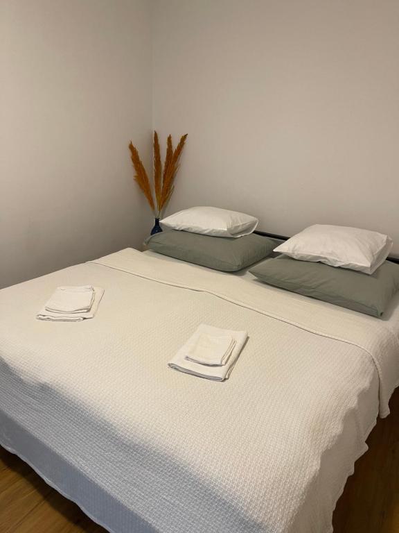 a large bed with white sheets and towels on it at Apartment Hilde in Schwaz