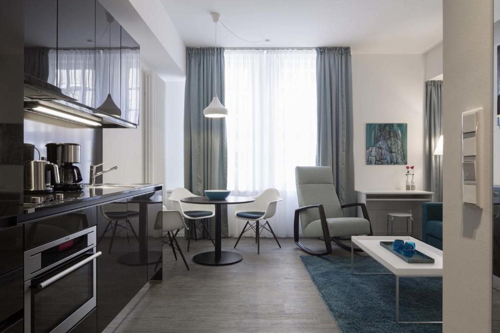 a kitchen and living room with a table and chairs at Boardinghouse Münster in Münster