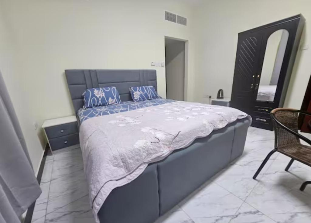 um quarto com uma cama grande e almofadas azuis em Pristine Private Bedroom in Dubai With Private Bathroom em Dubai