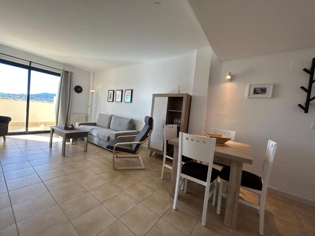 a living room with a couch and a table and chairs at Casa Cristina, Corvera in Corvera