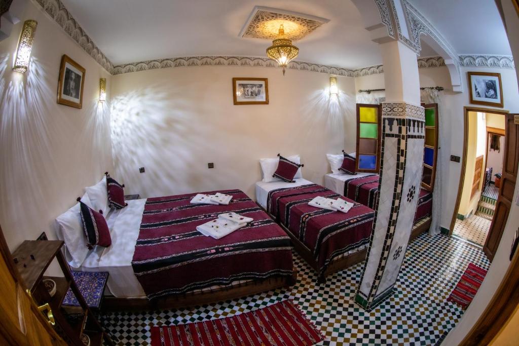 Postel nebo postele na pokoji v ubytování Dar alhaja rahma